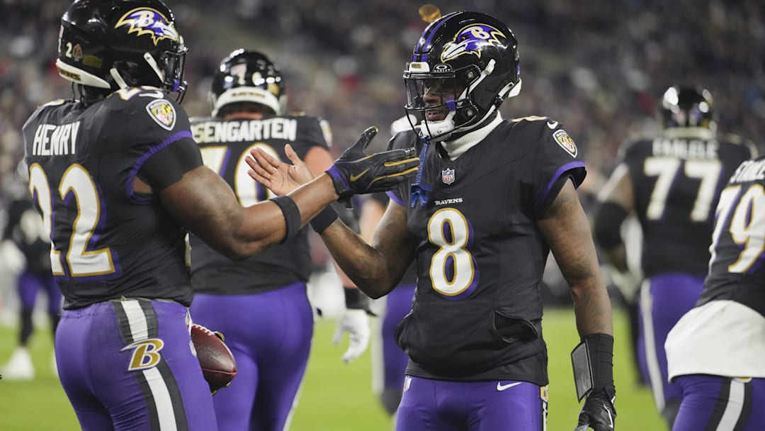 Dec 21, 2025; Baltimore, Maryland, USA;  Baltimore Ravens quarterback Lamar Jackson (8) congratulates running back Derrick Henry (22) on a touchdown run against the New England Patriots during the first quarter at M&T Bank Stadium. Mandatory Credit: Mitch Stringer-Imagn Images