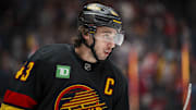 Oct 25, 2025; Vancouver, British Columbia, CAN; Vancouver Canucks defenseman Quinn Hughes (43) during a stop in play against the Montreal Canadiens in the first period at Rogers Arena. Mandatory Credit: Bob Frid-Imagn Images