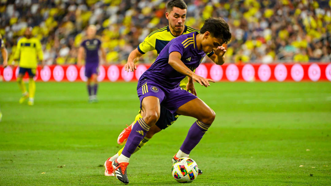 Jul 17, 2024; Nashville, Tennessee, USA;  Orlando City SC forward Ramiro Enrique (7) dribbles the ball against the Nashville SC during the second half at Geodis Park. Mandatory Credit: Steve Roberts-USA TODAY Sports