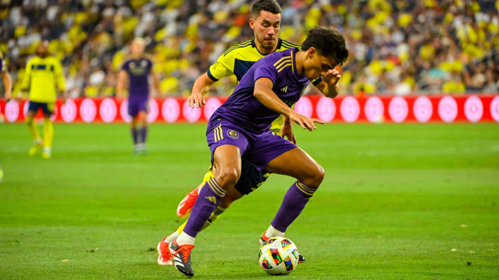 Jul 17, 2024; Nashville, Tennessee, USA;  Orlando City SC forward Ramiro Enrique (7) dribbles the ball against the Nashville SC during the second half at Geodis Park. Mandatory Credit: Steve Roberts-USA TODAY Sports