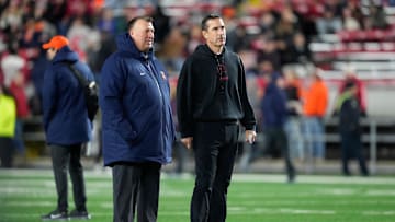 Nov 22, 2025; Madison, Wisconsin, USA; Illinois Fighting Illini head coach Bret Bielema, left, and Wisconsin Badgers head coach Luke Fickell, right, talk before a game at Camp Randall Stadium. Mandatory Credit: Kayla Wolf-Imagn Images