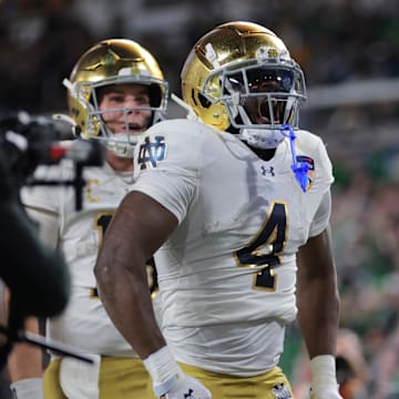 Jan 9, 2025; Miami, FL, USA; Notre Dame Fighting Irish running back Jeremiyah Love (4) celebrates a touch down in the second half against the Penn State Nittany Lions in the Orange Bowl at Hard Rock Stadium. 