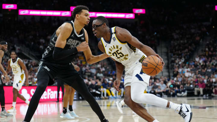 Mar 3, 2024; San Antonio, Texas, USA; Indiana Pacers forward Jalen Smith (25) dribbles against San Antonio Spurs center Victor Wembanyama (1) in the first half at Frost Bank Center. Mandatory Credit: Daniel Dunn-USA TODAY Sports