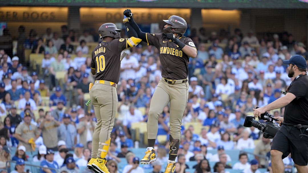 Oct 6, 2024; Los Angeles, California, USA; San Diego Padres outfielder Fernando Tatis Jr. (23) celebrates with outfielder Jurickson Profar (10) after hitting a solo home run in the first inning against the Los Angeles Dodgers during game two of the NLDS for the 2024 MLB Playoffs at Dodger Stadium. Mandatory Credit: Jayne Kamin-Oncea-Imagn Images