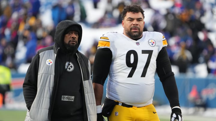 Jan 15, 2024; Orchard Park, New York, USA; Pittsburgh Steelers head coach Mike Tomlin walks the field with  defensive tackle Cameron Heyward (97) before the game against the Buffalo Bills in a 2024 AFC wild card game at Highmark Stadium. Mandatory Credit: Kirby Lee-USA TODAY Sports