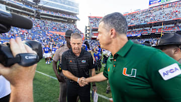 Florida Gators head coach Billy Napier, left shakes hands with Miami Hurricanes head coach Mario Cristobal after the Hurricanes defeated the Gators during the season opener at Ben Hill Griffin Stadium in Gainesville, FL on Saturday, August 31, 2024 against the University of Miami Hurricanes. The Hurricanes defeated the Gators 41-17. [Doug Engle/Gainesville Sun]