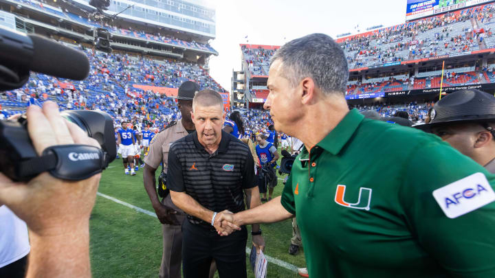 Florida Gators head coach Billy Napier, left shakes hands with Miami Hurricanes head coach Mario Cristobal after the Hurricanes defeated the Gators during the season opener at Ben Hill Griffin Stadium in Gainesville, FL on Saturday, August 31, 2024 against the University of Miami Hurricanes. The Hurricanes defeated the Gators 41-17. [Doug Engle/Gainesville Sun]