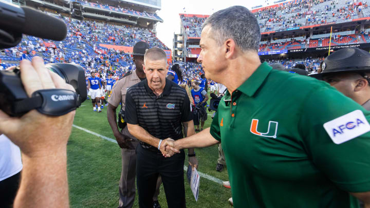 Florida Gators head coach Billy Napier, left shakes hands with Miami Hurricanes head coach Mario Cristobal after the Hurricanes defeated the Gators during the season opener at Ben Hill Griffin Stadium in Gainesville, FL on Saturday, August 31, 2024 against the University of Miami Hurricanes. The Hurricanes defeated the Gators 41-17. [Doug Engle/Gainesville Sun]