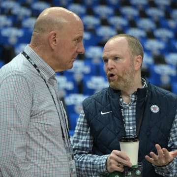 Apr 21, 2024; Los Angeles, California, USA; Los Angeles Clippers owner Steve Ballmer, left, talks with Lawrence Frank, President of Basketball Operations, prior to game one of the first round for the 2024 NBA playoffs against the Dallas Mavericks at Crypto.com Arena. 
