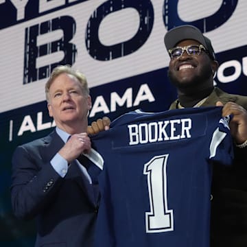 NFL commissioner Roger Goodell with Alabama Crimson Tide offensive lineman Tyler Booker after he is selected by the Dallas Cowboys as the number twelve pick in the first round of the 2025 NFL Draft at Lambeau Field. 
