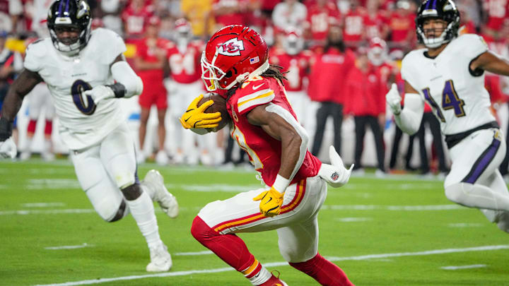 Sep 5, 2024; Kansas City, Missouri, USA; Kansas City Chiefs running back Isiah Pacheco (10) runs the ball as Baltimore Ravens linebacker Roquan Smith (0) chases during the first half at GEHA Field at Arrowhead Stadium. Mandatory Credit: Denny Medley-Imagn Images