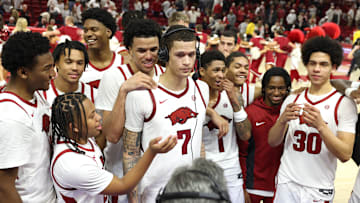 Dec 3, 2025; Fayetteville, Arkansas, USA; Arkansas Razorbacks forward Trevon Brazile (7) surrounded by teammates, talks to broadcasters after a game against Louisville Cardinals at Bud Walton Arena. Arkansas won 89-80. Mandatory Credit: Nelson Chenault-Imagn Images