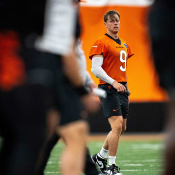 Cincinnati Bengals quarterback Joe Burrow (9) stretches with the rest of the team at Bengals spring practice at the IEL Indoor Facility in Cincinnati on Tuesday, June 11, 2024.