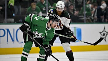 Mar 20, 2024; Dallas, Texas, USA; Arizona Coyotes center Liam O'Brien (38) shoves Dallas Stars center Radek Faksa (12) at the face-off circle and draws a game misconduct penalty during the third period at the American Airlines Center. Mandatory Credit: Jerome Miron-Imagn Images