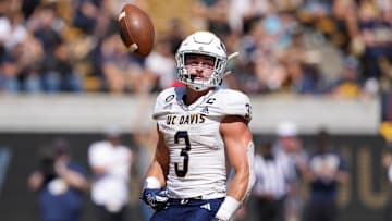 Aug 31, 2024; Berkeley, California, USA; UC Davis Aggies running back Lan Larison (3) flips the ball into the air after scoring a touchdown against the California Golden Bears during the second quarter at California Memorial Stadium.