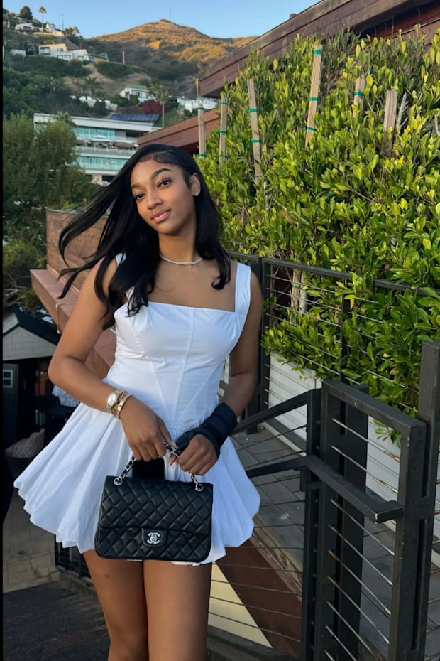 Angel Reese towers over Usher at concert in stunning white dress