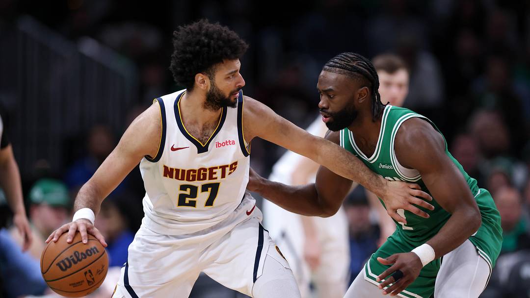 Mar 2, 2025; Boston, Massachusetts, USA; Denver Nuggets guard Jamal Murray (27) defended by Boston Celtics forward Jaylen Brown (7) during the second half at TD Garden. Mandatory Credit: Paul Rutherford-Imagn Images