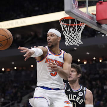 New York Knicks guard Josh Hart drives to the basket against Milwaukee Bucks center Brook Lopez. Mandatory Credit: Michael McLoone-Imagn Images