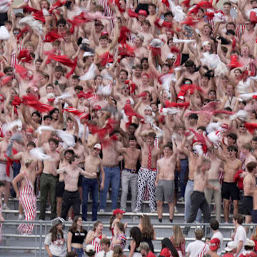 Spectators in the student section take off their shirts and cheers during the third quarter of the Wisconsin - Ohio State game Saturday, October 18, 2025 at Camp Randall Stadium in Madison, Wisconsin.