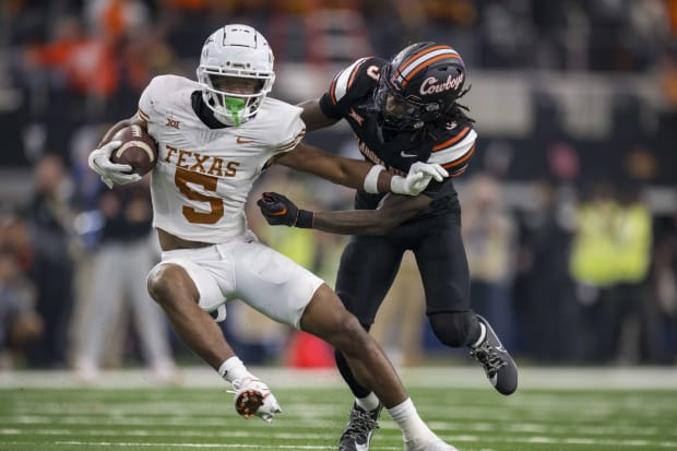 Texas Longhorns wide receiver Adonai Mitchell (5) and Oklahoma State Cowboys cornerback Cam Smith (3) in action during the game between the Texas Longhorns and the Oklahoma State Cowboys.