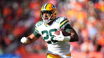 Oct 22, 2023; Denver, Colorado, USA; Green Bay Packers running back AJ Dillon (28) carries the ball in the second quarter against the Denver Broncos at Empower Field at Mile High. Mandatory Credit: Ron Chenoy-Imagn Images