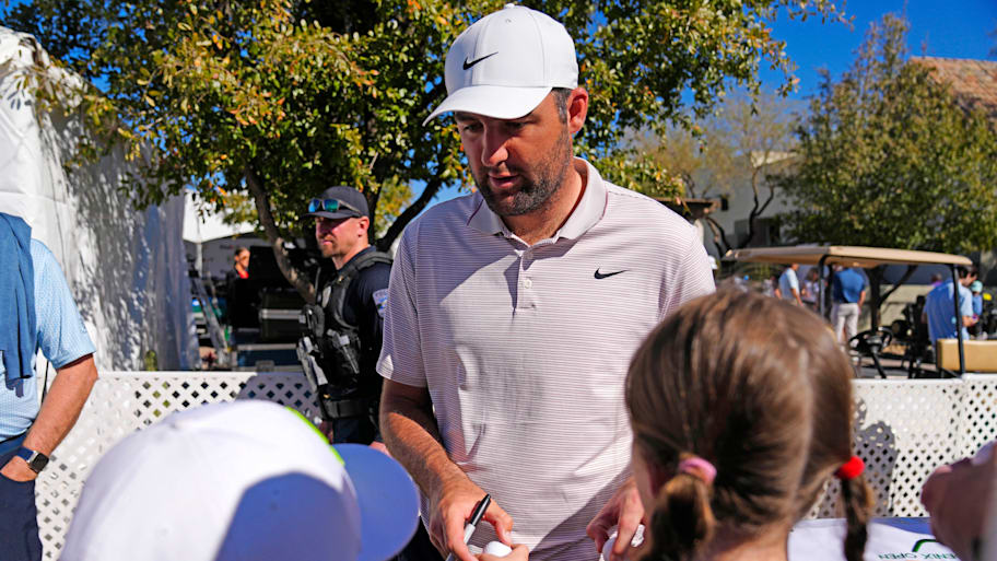 PGA golfer Scottie Scheffler signs autographs for young fans during the 2025 WM Phoenix Open pro-am at TPC Scottsdale.