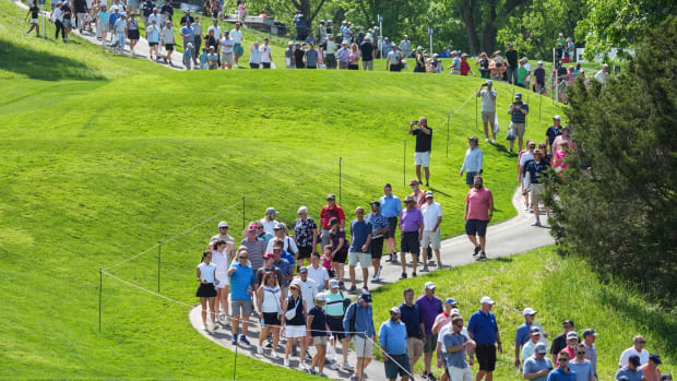 A group of spectators look onwards at the practice rounds at the Valhalla Golf Club