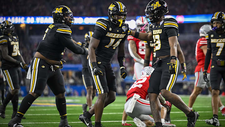 Dec 29, 2023; Arlington, TX, USA; Missouri Tigers linebacker Triston Newson (14) and defensive back Daylan Carnell (13) celebrate a defensive stop on the Ohio State Buckeyes during the second quarter at AT&T Stadium. Mandatory Credit: Jerome Miron-Imagn Images