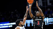 Dec 9, 2023; Cincinnati, Ohio, USA; Cincinnati Bearcats guard Jizzle James (2) shoot the ball defended by  Xavier Musketeers guard Dayvion McKnight (20) defends in the first half at Cintas Center. Mandatory Credit: Kareem Elgazzar-Imagn Images