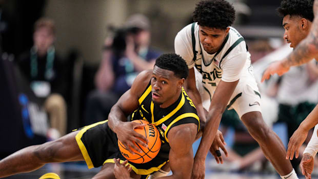 Oregon Ducks guard TJ Bamba (5) dives for the ball against Michigan State Spartans guard Jase Richardson (11)
