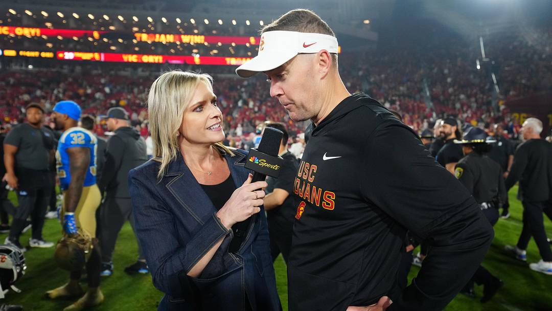 Nov 29, 2025; Los Angeles, California, USA; Southern California Trojans head coach Lincoln Riley (right) is interviewed by NBC Sports reporter Kathryn Tappen after the game against the UCLA Bruins at United Airlines Field at Los Angeles Memorial Coliseum. Mandatory Credit: Kirby Lee-Imagn Images Nov 29, 2025; Los Angeles, California, USA; Southern California Trojans head coach Lincoln Riley (right) is interviewed by NBC Sports reporter Kathryn Tappen after the game against the UCLA Bruins at United Airlines Field at Los Angeles Memorial Coliseum. Mandatory Credit: Kirby Lee-Imagn Images