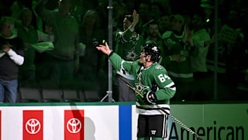 May 13, 2025; Dallas, Texas, USA; Dallas Stars center Mikael Granlund (64) tosses a puck to a fan after the Stars defeat the Winnipeg Jets in game four of the second round of the 2025 Stanley Cup Playoffs at American Airlines Center. Mandatory Credit: Jerome Miron-Imagn Images