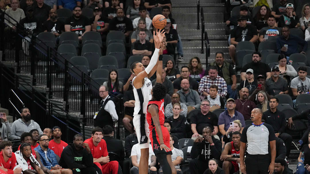 Oct 18, 2023; San Antonio, Texas, USA; San Antonio Spurs center Victor Wembanyama (1) shoots over Houston Rockets forward Amen Thompson (1) in the first half at the Frost Bank Center. Mandatory Credit: Daniel Dunn-Imagn Images