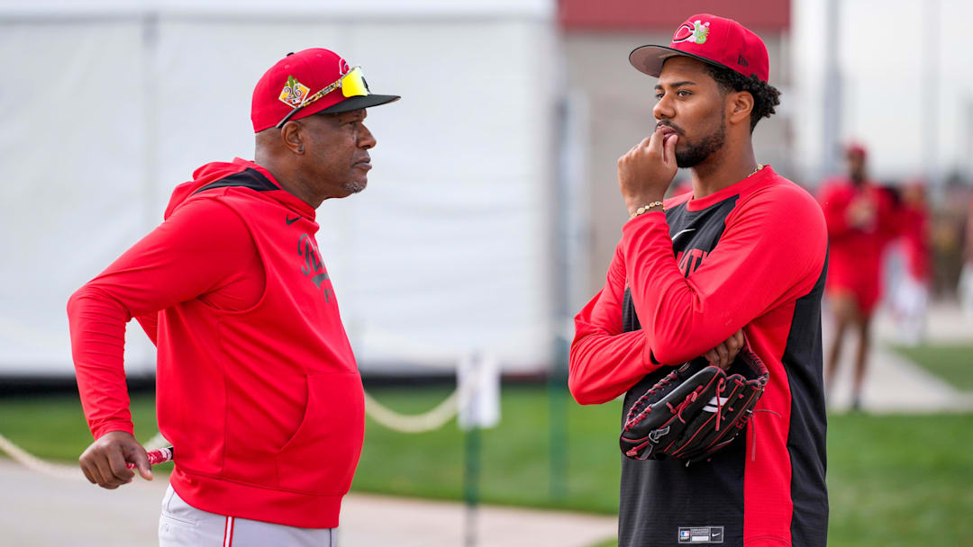 Cincinnati Reds pitcher Hunter Greene (21) talks with special assistant to the general manager, Eric Davis, at the Cincinnati Reds player development complex in Goodyear, Ariz., on Wednesday, Feb. 11, 2026.