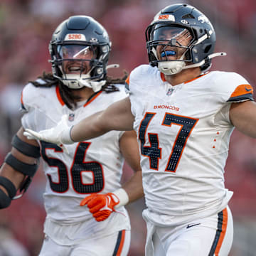 August 9, 2025; Santa Clara, California, USA; Denver Broncos linebacker Karene Reid (47) celebrates intercepting the football with linebacker Levelle Bailey (56) against the San Francisco 49ers during the second quarter at Levi's Stadium. Mandatory Credit: Kyle Terada-Imagn Images