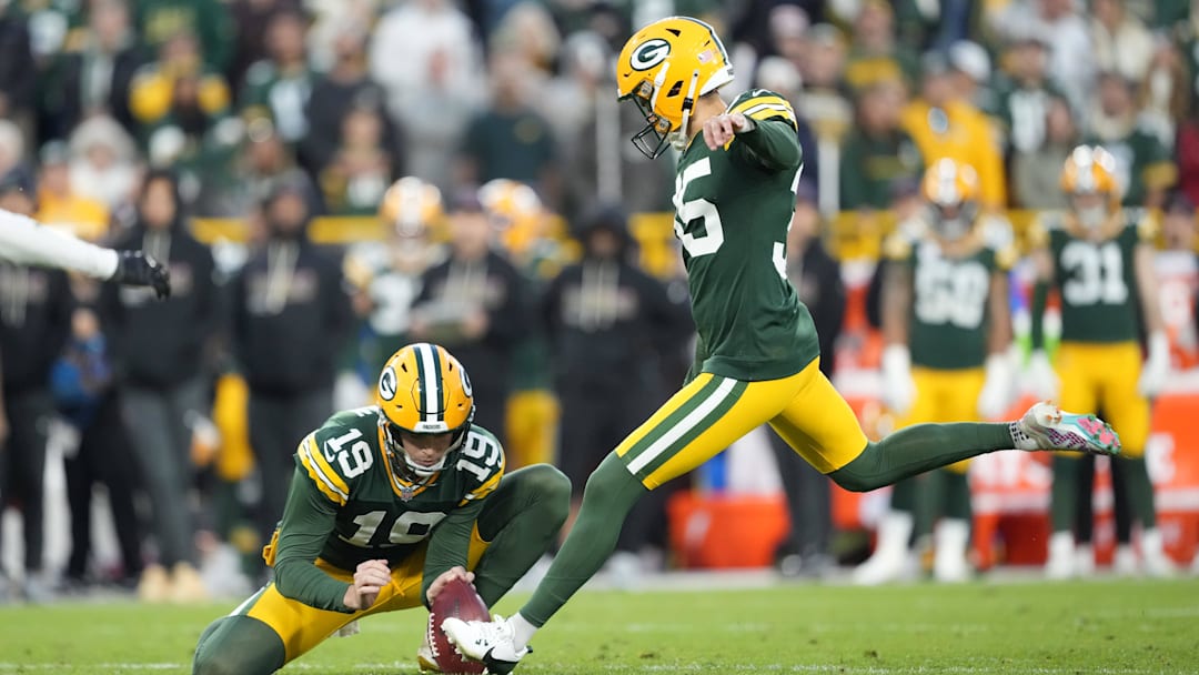 Oct 12, 2025; Green Bay, Wisconsin, USA; Green Bay Packers kicker Lucas Havrisik (35) kicks a field goal with  punter Daniel Whelan (19) in the fourth quarter against the Cincinnati Bengals at Lambeau Field. Mandatory Credit: Jeff Hanisch-Imagn Images