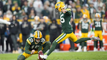 Oct 12, 2025; Green Bay, Wisconsin, USA; Green Bay Packers kicker Lucas Havrisik (35) kicks a field goal with  punter Daniel Whelan (19) in the fourth quarter against the Cincinnati Bengals at Lambeau Field. Mandatory Credit: Jeff Hanisch-Imagn Images