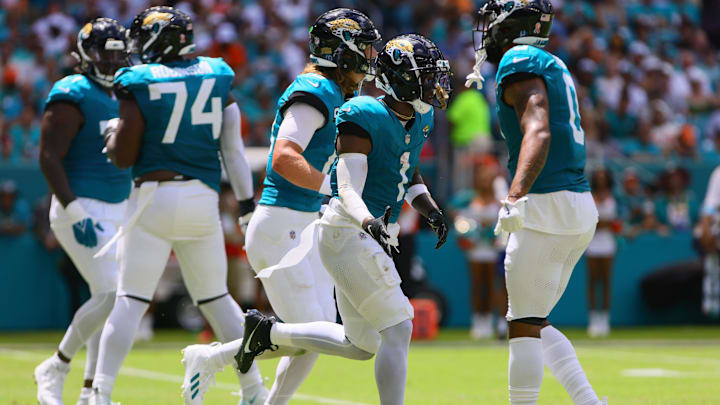 Sep 8, 2024; Miami Gardens, Florida, USA; Jacksonville Jaguars running back Travis Etienne Jr. (1) celebrates after scoring a touchdown against the Miami Dolphins during the first quarter at Hard Rock Stadium. Mandatory Credit: Sam Navarro-Imagn Images