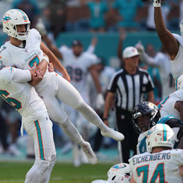 Miami Dolphins punter Jake Bailey (16) lifts Miami Dolphins kicker Jason Sanders (7) after his game winning field goal against the Jacksonville Jaguars at Hard Rock Stadium.