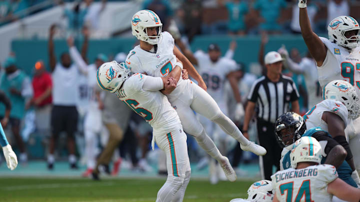 Miami Dolphins punter Jake Bailey (16) lifts Miami Dolphins kicker Jason Sanders (7) after his game winning field goal against the Jacksonville Jaguars at Hard Rock Stadium.