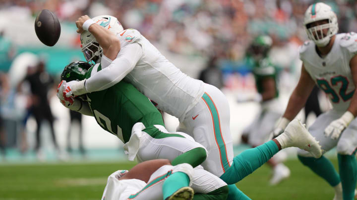 Bradley Chubb drills New York Jets quarterback Zach Wilson to cause a fumble during the first half of the game at Hard Rock Stadium last December.