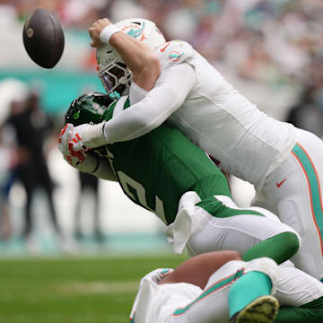 Miami Dolphins linebacker Bradley Chubb hits New York Jets quarterback Zach Wilson, causing a fumble.