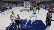 Jun 12, 2024; Dallas, Texas, USA; Boston Celtics guard Jaylen Brown (7) goes up for a basket against Dallas Mavericks forward Maxi Kleber (42) and guard Kyrie Irving (right) during the first half during game three of the 2024 NBA Finals at American Airlines Center. Mandatory Credit: Julio Cortez/Pool Photo-USA TODAY Sports