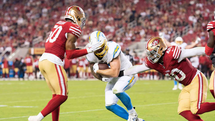 Aug 25, 2023; Santa Clara, California, USA; Los Angeles Chargers tight end Hunter Kampmoyer (87) fights for the touchdown during the third quarter against San Francisco 49ers linebacker Jalen Graham (50) and linebacker Marcelino McCrary-Ball (40) at Levi's Stadium. Mandatory Credit: Stan Szeto-USA TODAY Sports