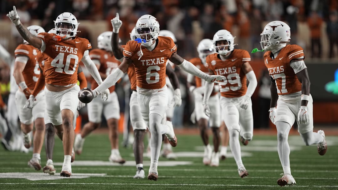Texas Longhorns defensive back Kobe Black (6) and teammates react after making an interception during the second half.
