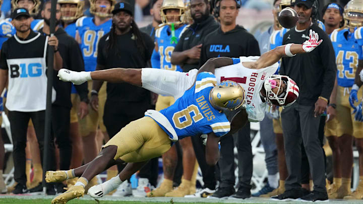 Sep 14, 2024; Pasadena, California, USA; Indiana Hoosiers wide receiver Elijah Sarratt (13) attempts to catch the ball against UCLA Bruins defensive back Jaylin Davies (6) in the second half at Rose Bowl. Mandatory Credit: Kirby Lee-Imagn Images