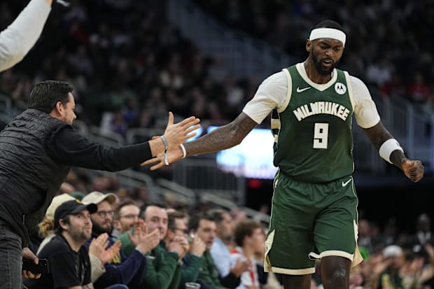 Milwaukee Bucks forward Bobby Portis (9) celebrates with a fan after scoring a basket against the Chicago Bulls in 2023-24.