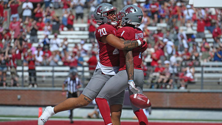 Aug 31, 2024; Pullman, Washington, USA; Washington State Cougars running back Leo Pulalasi (20) and wide receiver Kris Hutson (1) celebrate a touchdown against the Portland State Vikings in the first half at Gesa Field at Martin Stadium. Mandatory Credit: James Snook-USA TODAY Sports