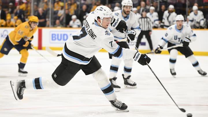 Apr 14, 2025; Nashville, Tennessee, USA;  Utah Hockey Club defenseman Michael Kesselring (7) shoots against the Nashville Predators during the second period at Bridgestone Arena. Mandatory Credit: Steve Roberts-Imagn Images