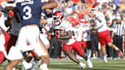 Oct 12, 2024; Charlottesville, Virginia, USA; Louisville Cardinals running back Isaac Brown (25) carries the ball to score a touchdown during the first half against the Virginia Cavaliers at Scott Stadium. Mandatory Credit: Amber Searls-Imagn Images